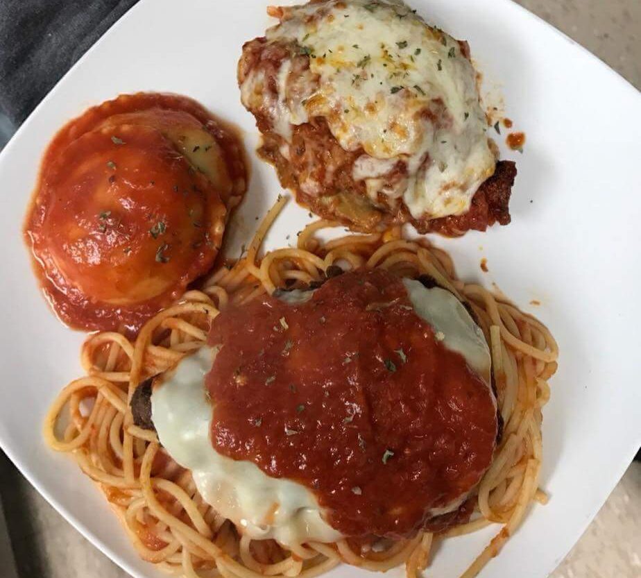 chicken parmesan with raviolo and pasta